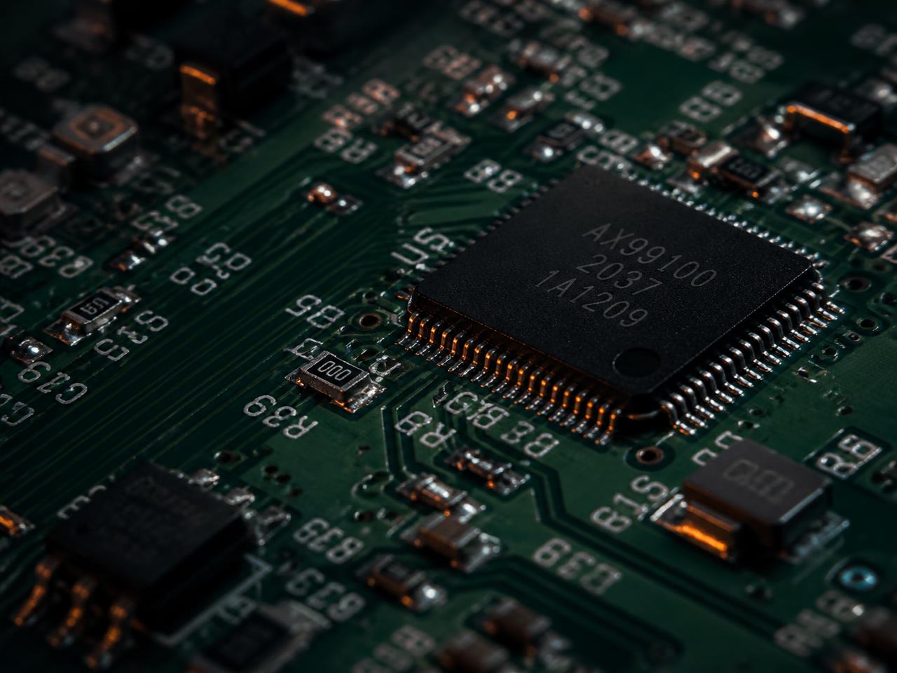 Macro view of a printed circuit board with copper traces and surface-mount components